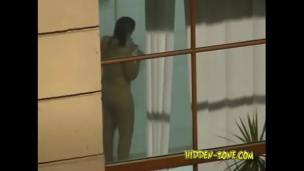 Νέος A girl washes in the shower, and we see her through the window λεπτός σωλήνας